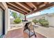 Covered patio with a stainless steel outdoor BBQ grill and a gravel yard at 6215 E Surrey Ave, Scottsdale, AZ 85254