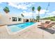 Inviting backyard pool with lounge chairs and string lights is perfect for outdoor relaxation and entertaining at 6215 E Surrey Ave, Scottsdale, AZ 85254