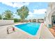 A sparkling in-ground pool and covered outdoor dining create an inviting backyard oasis at 6215 E Surrey Ave, Scottsdale, AZ 85254