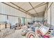A well lit storage shed featuring a metal roof and an array of tires and equipment at 6215 E Surrey Ave, Scottsdale, AZ 85254