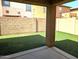 View of backyard featuring artificial grass and privacy wall offering a serene outdoor retreat at 6388 W Ruth Ave, Glendale, AZ 85302