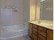 Bathroom with a double sink vanity and soaking tub, adorned with elegant decor and ample lighting at 6388 W Ruth Ave, Glendale, AZ 85302