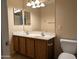 Bathroom with double sink vanity, large mirror, and a clean, well-maintained toilet at 6388 W Ruth Ave, Glendale, AZ 85302