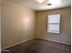Cozy bedroom with neutral color scheme, plush carpeting, and window with bright natural light at 6388 W Ruth Ave, Glendale, AZ 85302