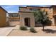 A two-story home with a tile roof, front-facing garage, desert landscaping, and stucco exterior at 6388 W Ruth Ave, Glendale, AZ 85302