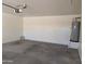 Spacious garage interior with concrete floors and water heater, offering functionality at 6388 W Ruth Ave, Glendale, AZ 85302