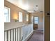 Well-lit hallway with neutral walls, white railing, and three large windows offering plenty of natural light at 6388 W Ruth Ave, Glendale, AZ 85302