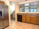 A kitchen displaying wooden cabinets, black appliances, an open concept, and an adjacent staircase at 6388 W Ruth Ave, Glendale, AZ 85302