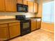 A kitchen featuring wooden cabinets, neutral countertops, tile flooring, and black appliances at 6388 W Ruth Ave, Glendale, AZ 85302