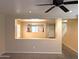 Inviting living room featuring neutral tones, an open view into the kitchen, and modern ceiling fan at 6388 W Ruth Ave, Glendale, AZ 85302