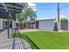 Backyard view of the artificial lawn, gravel, and pergola at 6908 E Windsor Ave, Scottsdale, AZ 85257