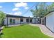 Exterior backyard view with an artificial lawn and a covered patio at 6908 E Windsor Ave, Scottsdale, AZ 85257