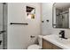 Renovated bathroom featuring gray tile, modern fixtures, and a framed vanity mirror at 6908 E Windsor Ave, Scottsdale, AZ 85257