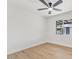 A bedroom with light wood flooring, white walls, a window, and ceiling fan at 6908 E Windsor Ave, Scottsdale, AZ 85257