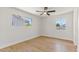 Bright bedroom with wood floor, white walls, and windows letting in natural light at 6908 E Windsor Ave, Scottsdale, AZ 85257