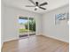Bright bedroom featuring wood floors and sliding glass doors leading to the backyard at 6908 E Windsor Ave, Scottsdale, AZ 85257
