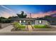Charming home with a well-manicured front yard and a beautifully lit exterior at 6908 E Windsor Ave, Scottsdale, AZ 85257