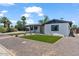Charming single-story home with front yard landscaping featuring artificial grass and desert foliage at 6908 E Windsor Ave, Scottsdale, AZ 85257