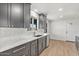 Modern kitchen with sleek gray cabinets, stainless steel appliances, and a stylish eat in kitchen at 6908 E Windsor Ave, Scottsdale, AZ 85257