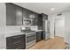 Updated kitchen featuring stainless steel appliances, dark cabinets, and sleek countertops at 6908 E Windsor Ave, Scottsdale, AZ 85257