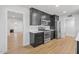 Modern kitchen featuring stainless steel appliances, dark cabinets, and open concept living space at 6908 E Windsor Ave, Scottsdale, AZ 85257