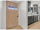 Modern kitchen featuring sleek gray cabinets, white countertops, and a stylish wood door to the exterior at 6908 E Windsor Ave, Scottsdale, AZ 85257