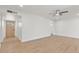 Spacious living room with wood-look flooring, recessed lighting, and a view to a light wood front door at 6908 E Windsor Ave, Scottsdale, AZ 85257