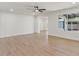 Expansive living area featuring modern lighting, wood-look floors, and seamless flow to other rooms at 6908 E Windsor Ave, Scottsdale, AZ 85257