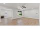 Bright living room features wood floors, modern ceiling fan, and ample natural light from multiple windows at 6908 E Windsor Ave, Scottsdale, AZ 85257