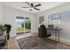 Well-lit office with a view of the fenced backyard, wood floors, and a ceiling fan at 6908 E Windsor Ave, Scottsdale, AZ 85257