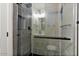 Contemporary shower stall featuring glass doors, gray tile, and black hardware at 6908 E Windsor Ave, Scottsdale, AZ 85257