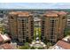Stunning aerial view of two high-rise condo buildings with a central pool and lush landscaping in a vibrant cityscape at 7181 E Camelback Rd # 702, Scottsdale, AZ 85251