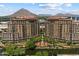Stunning aerial view of luxury condos with mountain views, lush landscaping, and water features at 7181 E Camelback Rd # 702, Scottsdale, AZ 85251