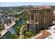 Beautiful aerial view of a luxury condo building next to a canal and bridge, offering scenic urban living at 7181 E Camelback Rd # 702, Scottsdale, AZ 85251