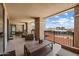 Wide balcony showing open seating, dining table, and views of mountains and city buildings at 7181 E Camelback Rd # 702, Scottsdale, AZ 85251