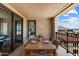 Balcony featuring patio table with seating, tile floor, and views of mountains in the distance at 7181 E Camelback Rd # 702, Scottsdale, AZ 85251