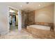 Luxurious bathroom featuring a walk-in closet, shower and soaking tub at 7181 E Camelback Rd # 702, Scottsdale, AZ 85251