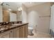 Bathroom features a marble vanity top, neutral walls, tiled floors, and a shower with neutral stone walls at 7181 E Camelback Rd # 702, Scottsdale, AZ 85251