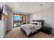Comfortable bedroom with access to a balcony and a view of the outdoors at 7181 E Camelback Rd # 702, Scottsdale, AZ 85251