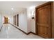 Long hallway showing multiple doors and wall decor; marble tile flooring at 7181 E Camelback Rd # 702, Scottsdale, AZ 85251