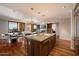 Open kitchen featuring an island, granite counters, and stainless appliances, flowing into the living space at 7181 E Camelback Rd # 702, Scottsdale, AZ 85251