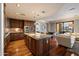 Kitchen island with bar seating, granite countertops, and seamless flow into living spaces and a balcony at 7181 E Camelback Rd # 702, Scottsdale, AZ 85251