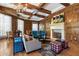 Comfortable living room with fireplace, wood paneling and beams, and ample seating at 7181 E Camelback Rd # 702, Scottsdale, AZ 85251
