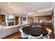 Open-concept living space featuring a fireplace, hardwood floors, and a modern kitchen with granite countertops at 7181 E Camelback Rd # 702, Scottsdale, AZ 85251