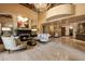 Elegant lobby with marble floors, fireplace, and comfortable seating under a chandelier at 7181 E Camelback Rd # 702, Scottsdale, AZ 85251