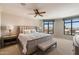 Bright main bedroom with plush carpet, ceiling fan, and large windows offering scenic views at 7181 E Camelback Rd # 702, Scottsdale, AZ 85251