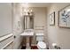 Charming powder room with pedestal sink, framed art, and classic fixtures at 7181 E Camelback Rd # 702, Scottsdale, AZ 85251