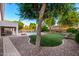 Spacious backyard with a pool, patio area with outdoor kitchen, and low-maintenance landscaping at 7247 W Buckskin Trl, Peoria, AZ 85383