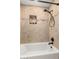 Bathroom shower showcasing neutral tile surround with a decorative mosaic accent and black shower fixture at 7247 W Buckskin Trl, Peoria, AZ 85383