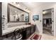 Stylish bathroom vanity with granite countertops, ample storage, and a large mirror at 7247 W Buckskin Trl, Peoria, AZ 85383